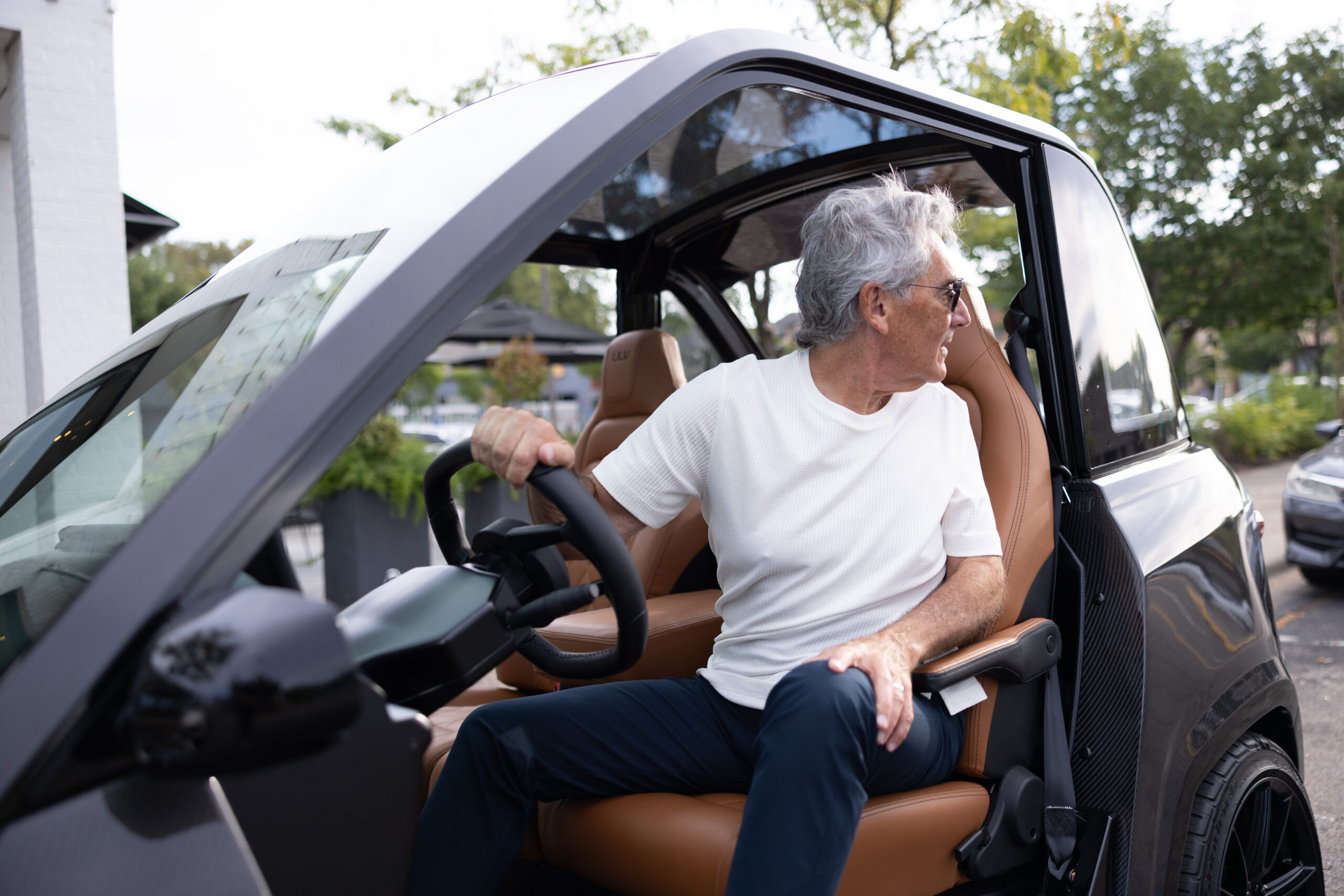 Man sitting in a ULV 322 carbon in black looking back as he backs up.