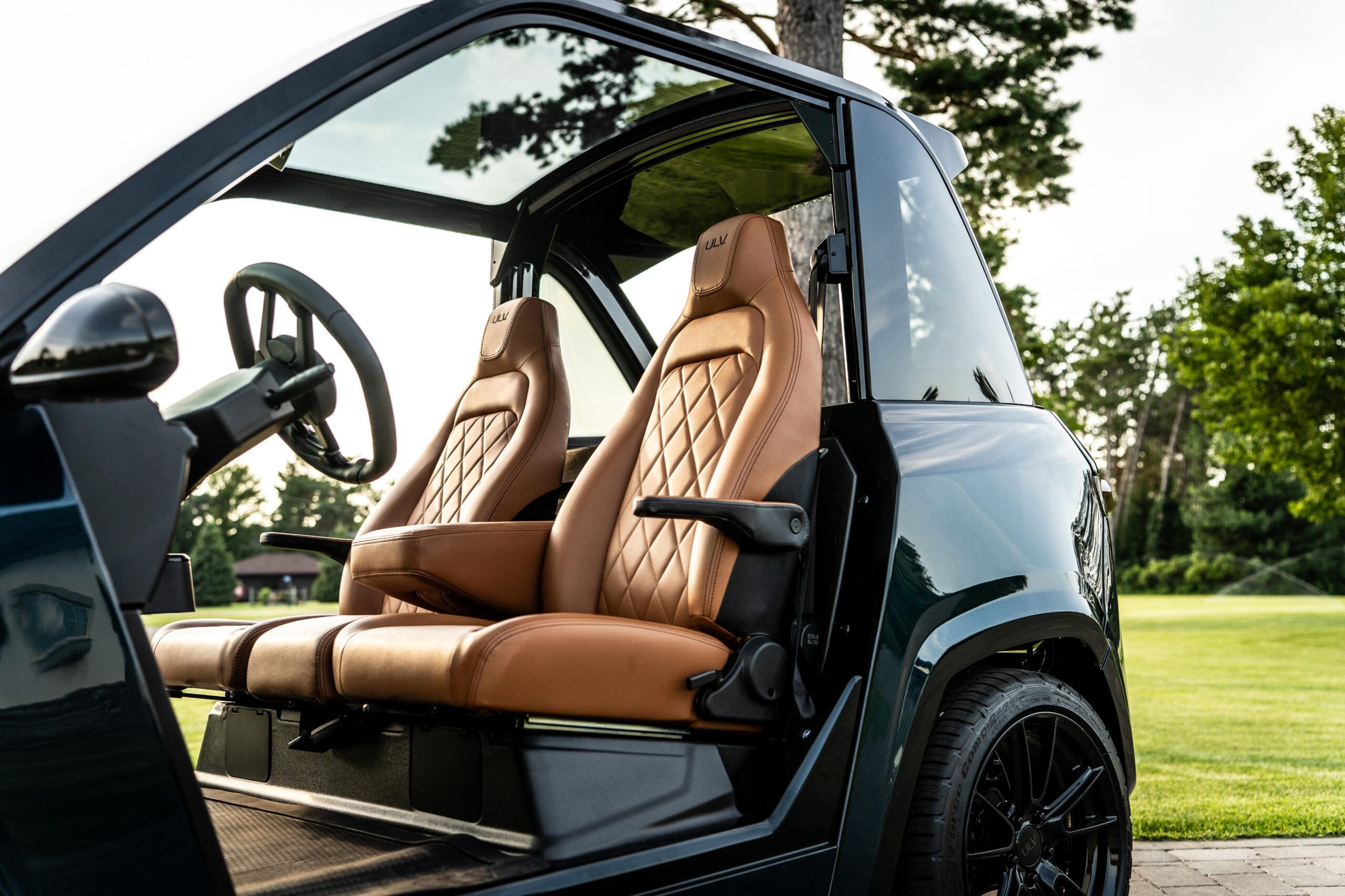 interior shot of the leather seats and steering wheel of a black ulv 322