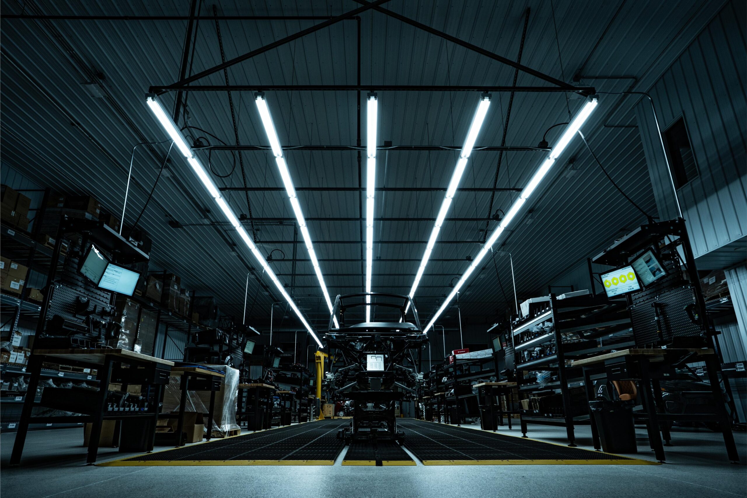 the chassis of a ulv 322 model illuminated dramatically by florescent factory lights